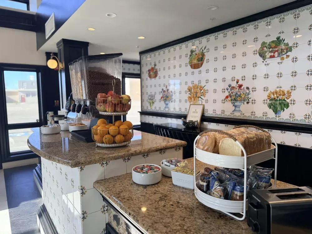 Bagels, bread and pastries beside the fruit bowl